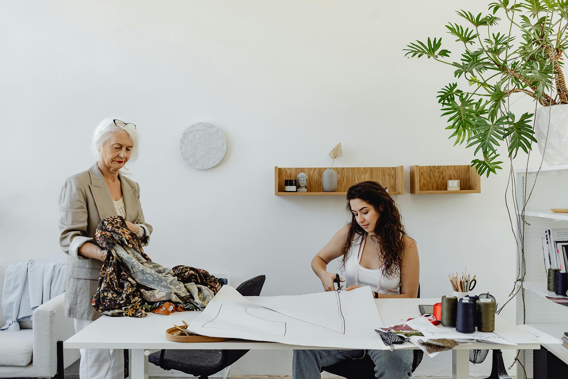 Two Women Cutting Clothing Patterns While Starting Small Fashion Business In Australia